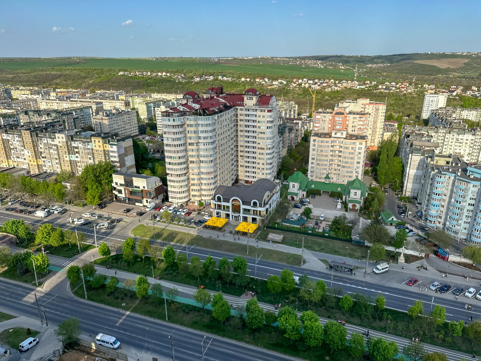 View from the apartment over the neighbourhood, a main road and green hills